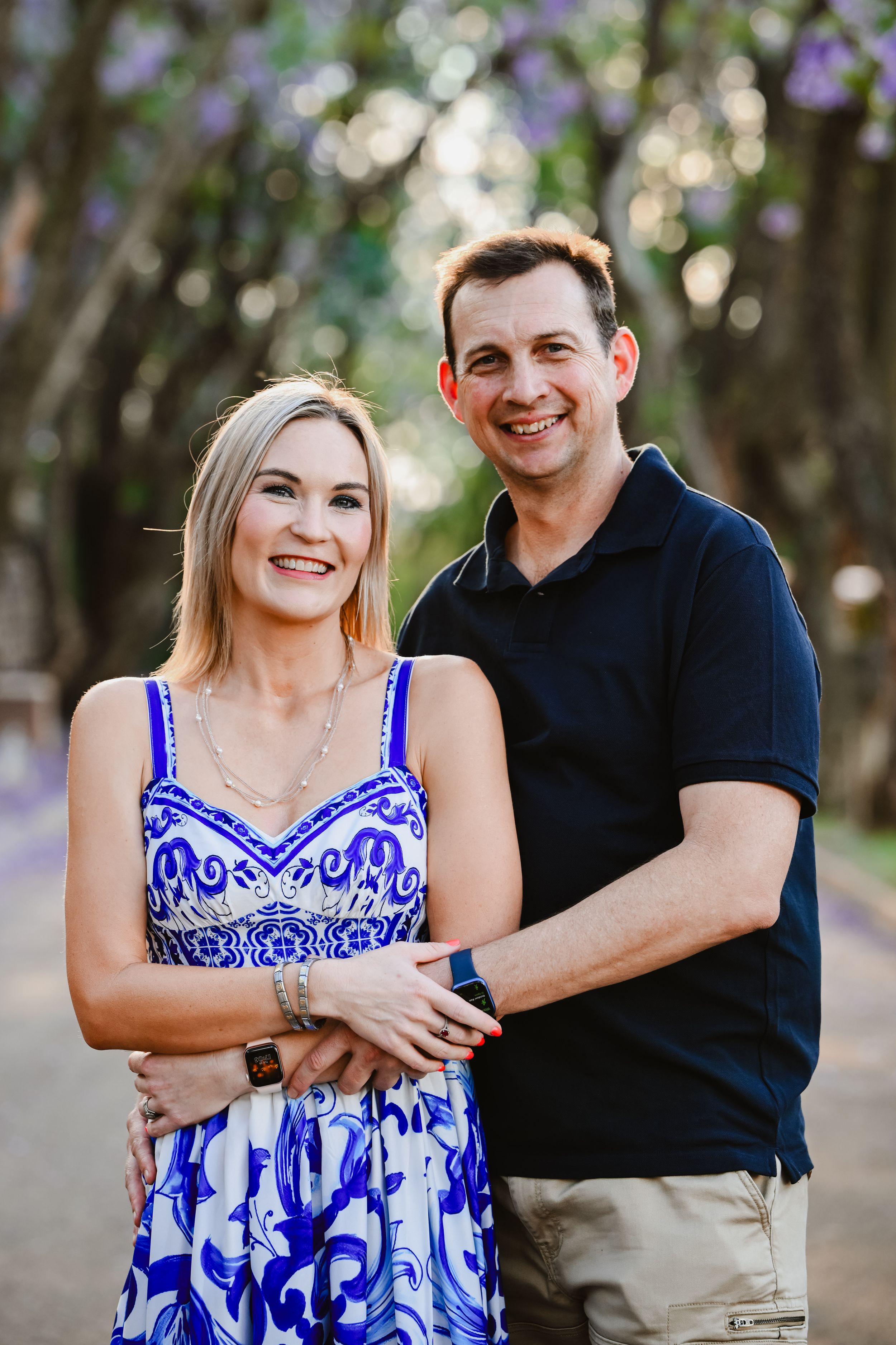 Mother and son portrait surrounded by blooming Jacaranda trees in Pretoria.