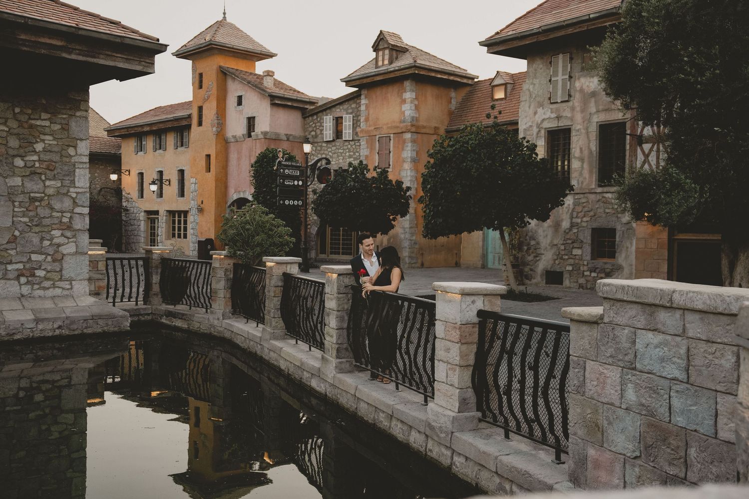 Romantic couple photoshoot in Dubai with scenic waterfront architecture