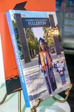 Several photo displays showing California State University Fullerton campus scenes mounted on stands.