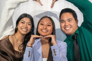 Group of friends posing playfully together at a formal event.