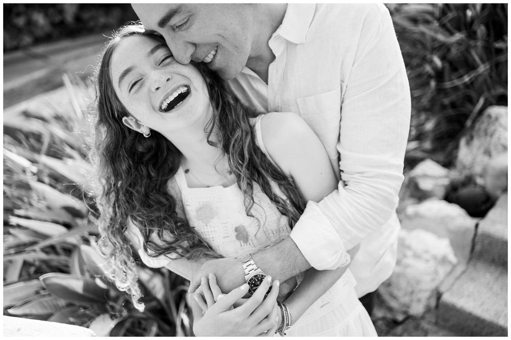 Black and white portrait of a couple laughing together during a family photo session at St. Regis Punta Mita.