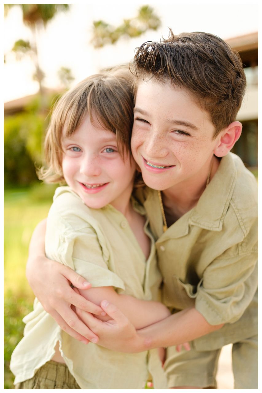 Close-up portrait of two children during a family photography session at St. Regis Punta Mita.
