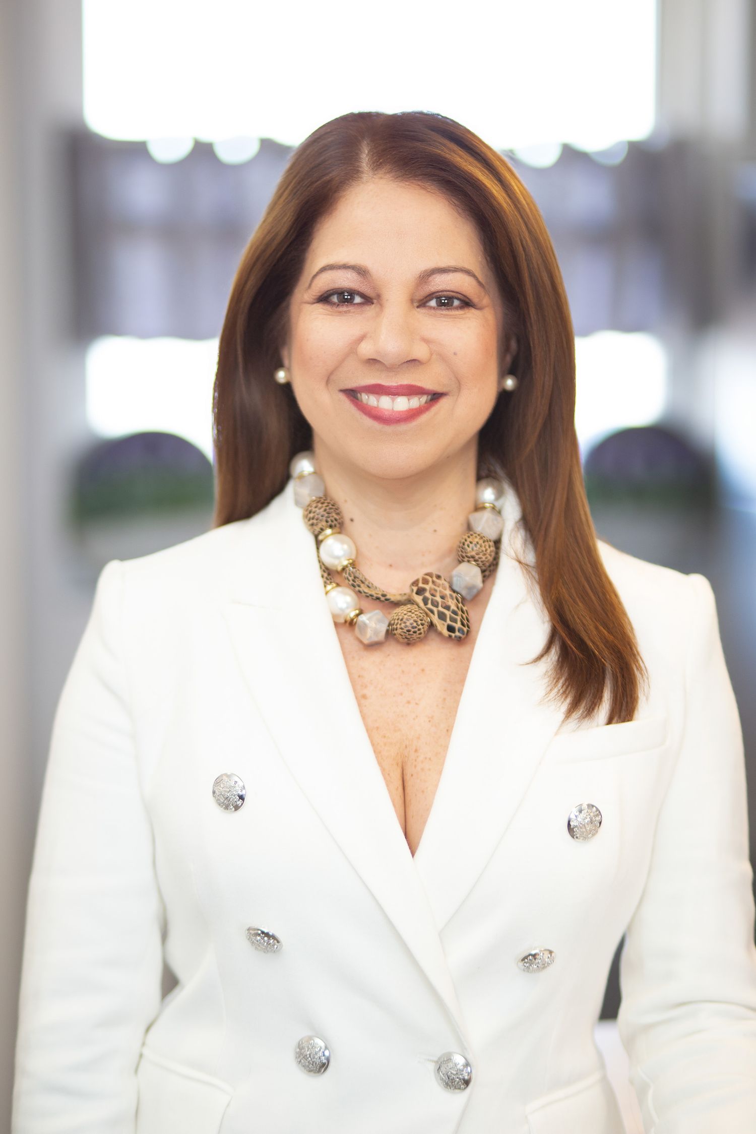 Branding photo of smiling realtor in neutral-toned kitchen | Northern NJ branding photography