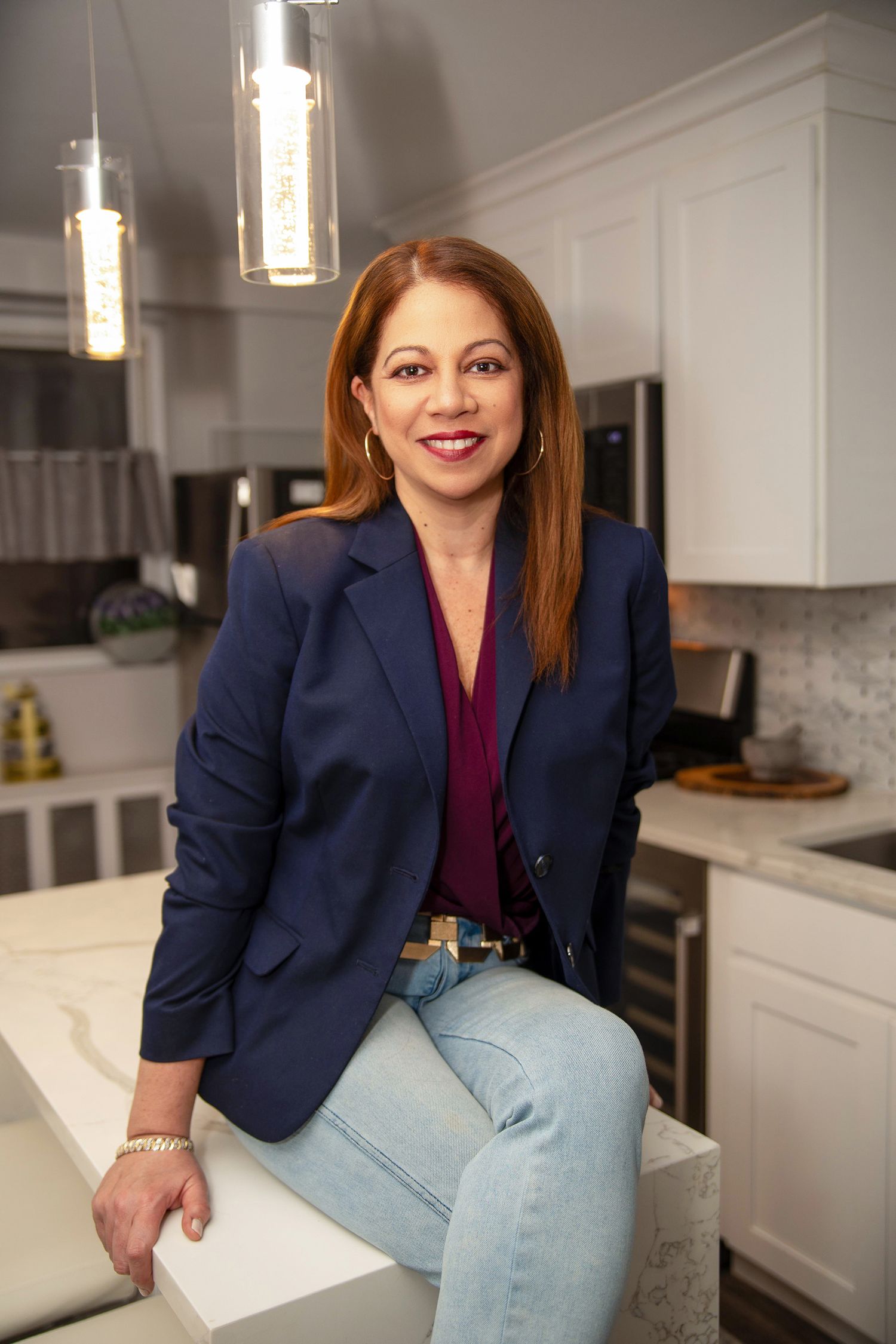 Approachable realtor posing in bright kitchen for lifestyle branding photos | Bergen County branding photographer