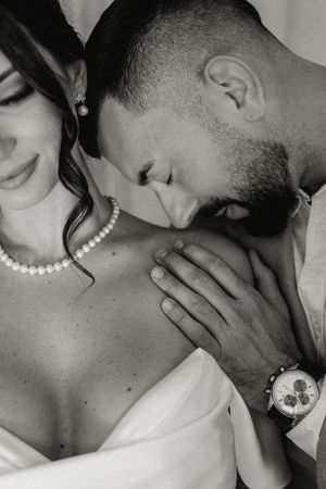 A romantic black and white close-up photo showing intimate affection between a couple.
