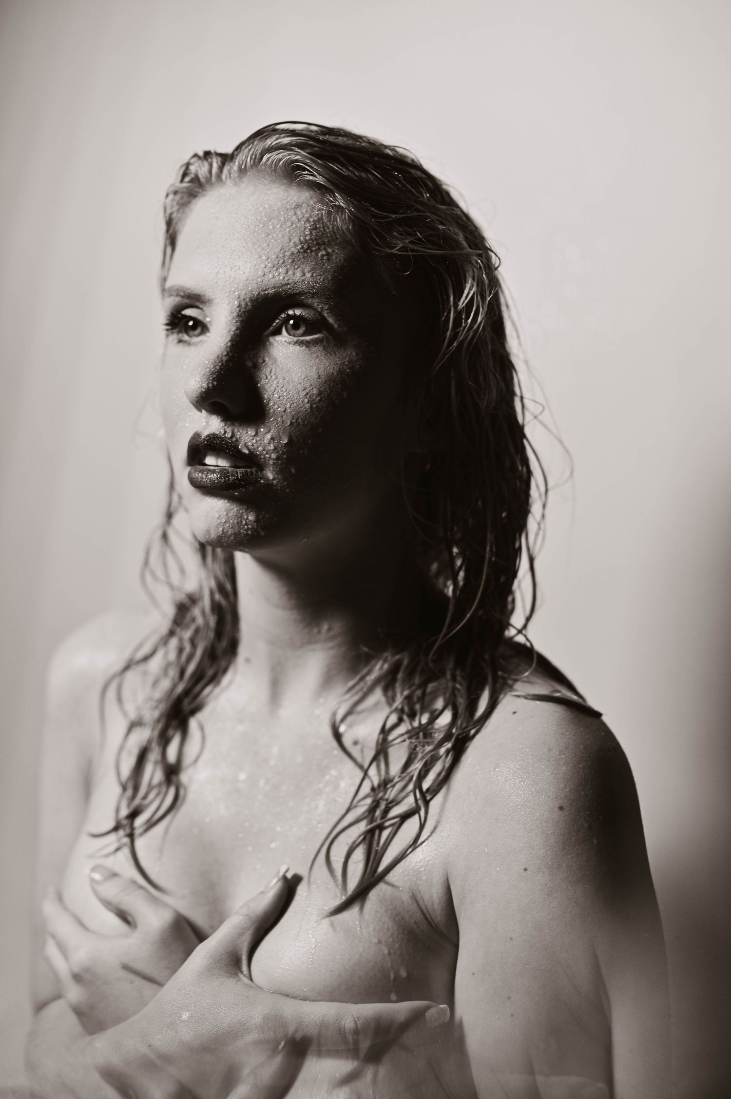 Artistic black and white portrait with wet hair effect.