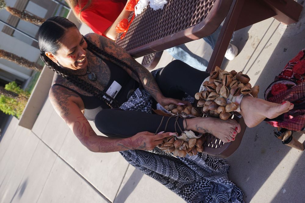 People gathered at an outdoor community event with decorative displays.