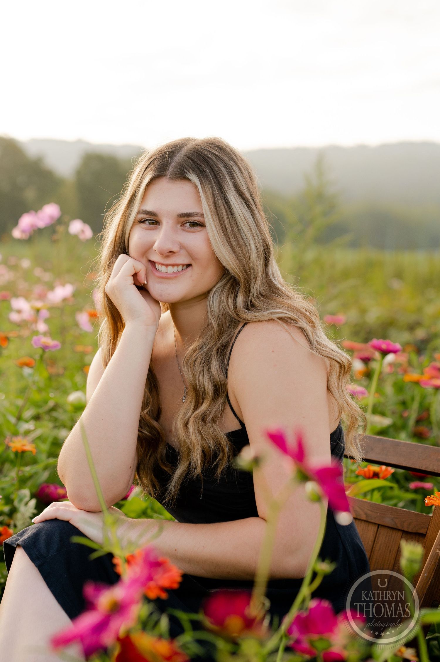 Candid portrait in a garden of colorful wildflowers during golden hour.