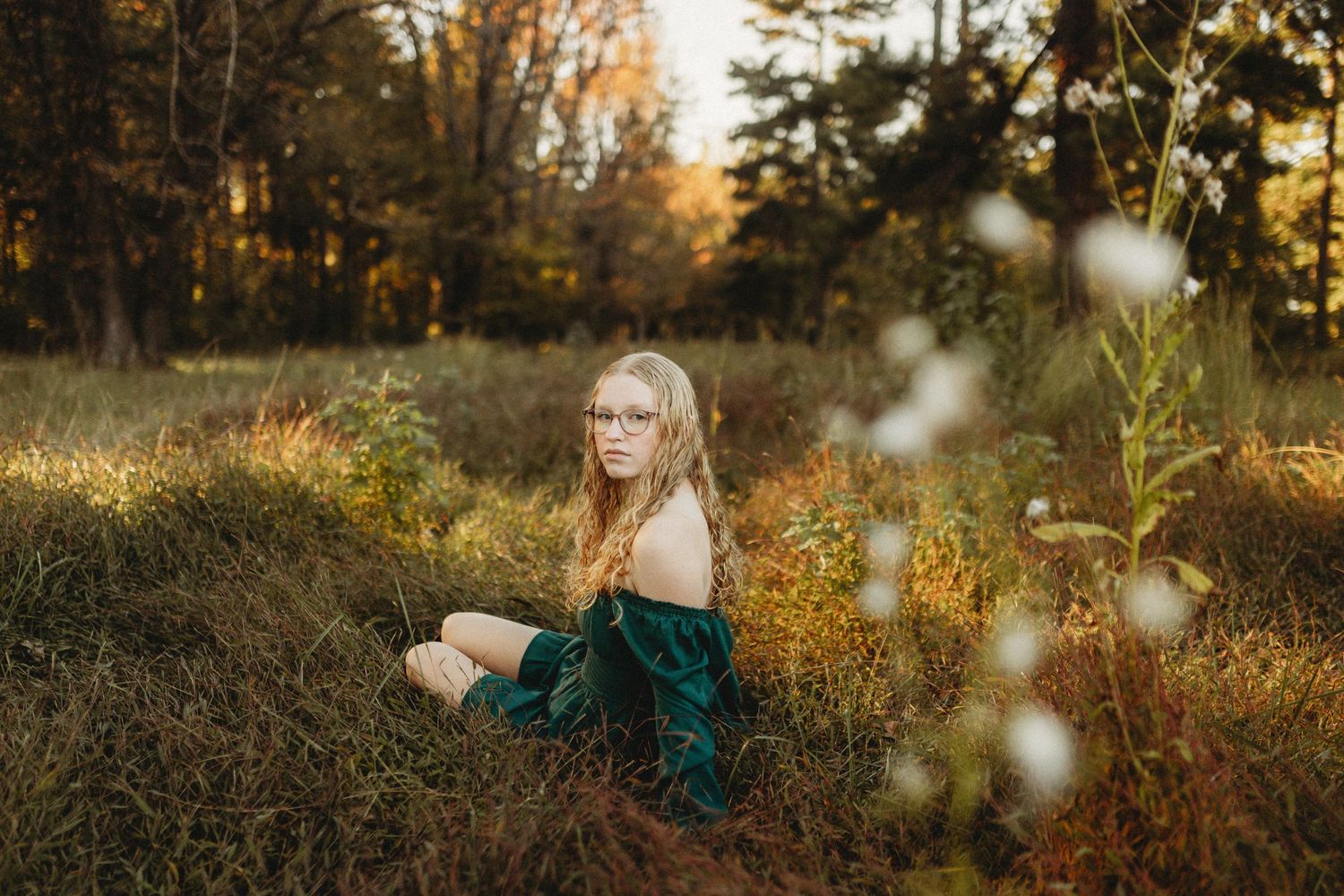 Senior girl sitting in a field