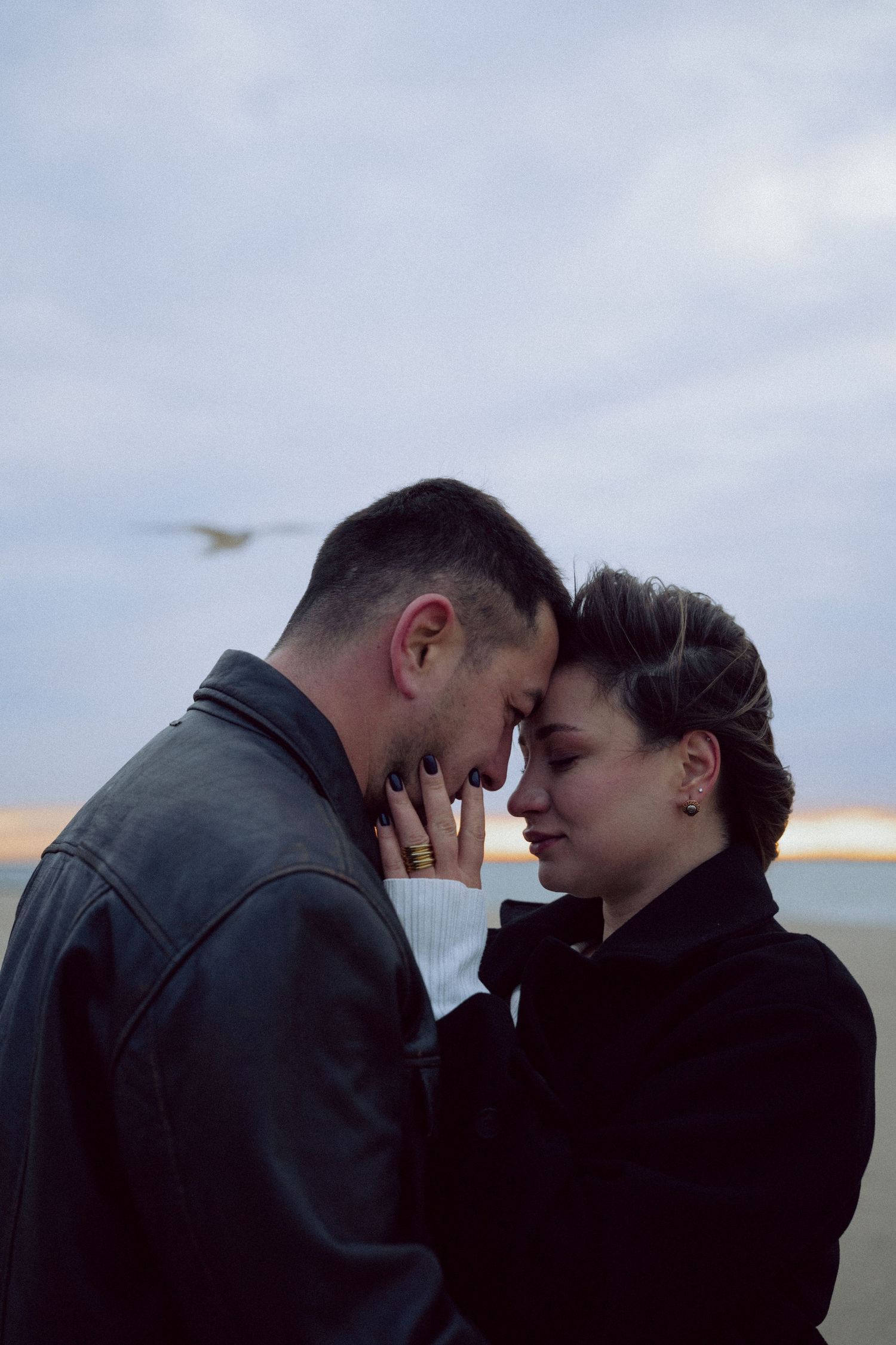 Emotional and breathtaking couple photoshoot by the ocean, capturing deep connection, movement, and raw beauty