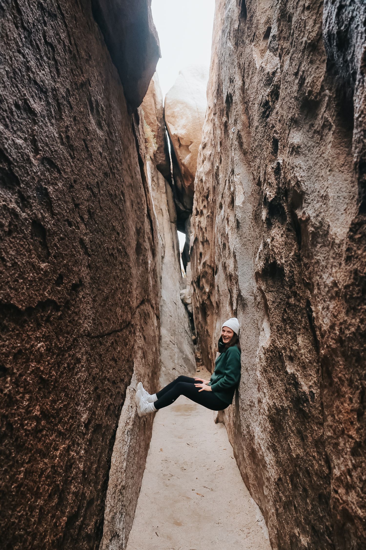 Adventure seeker wedged between narrow canyon walls.