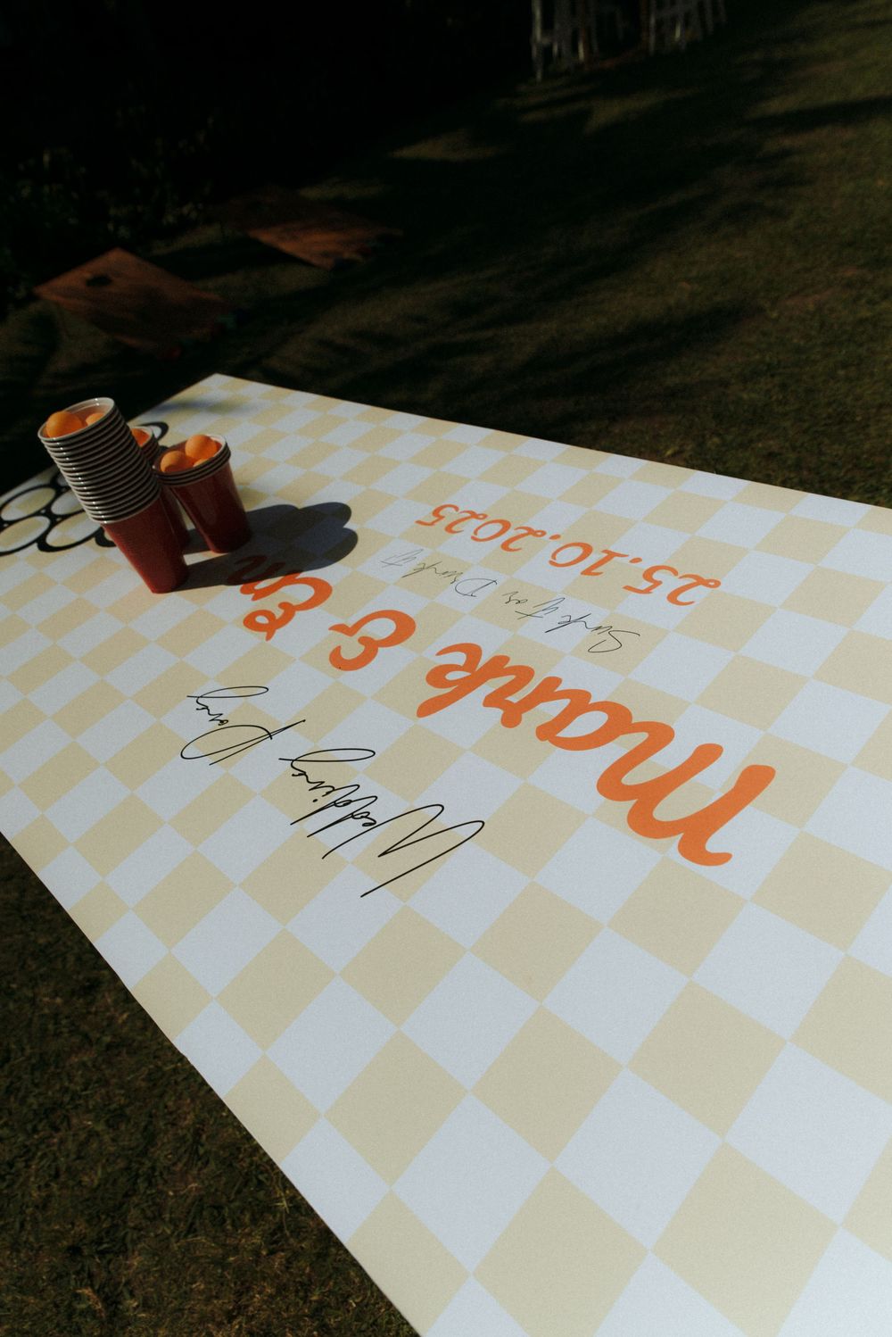 A series of five similar photos showing a white paper with orange text lying on grass or ground.