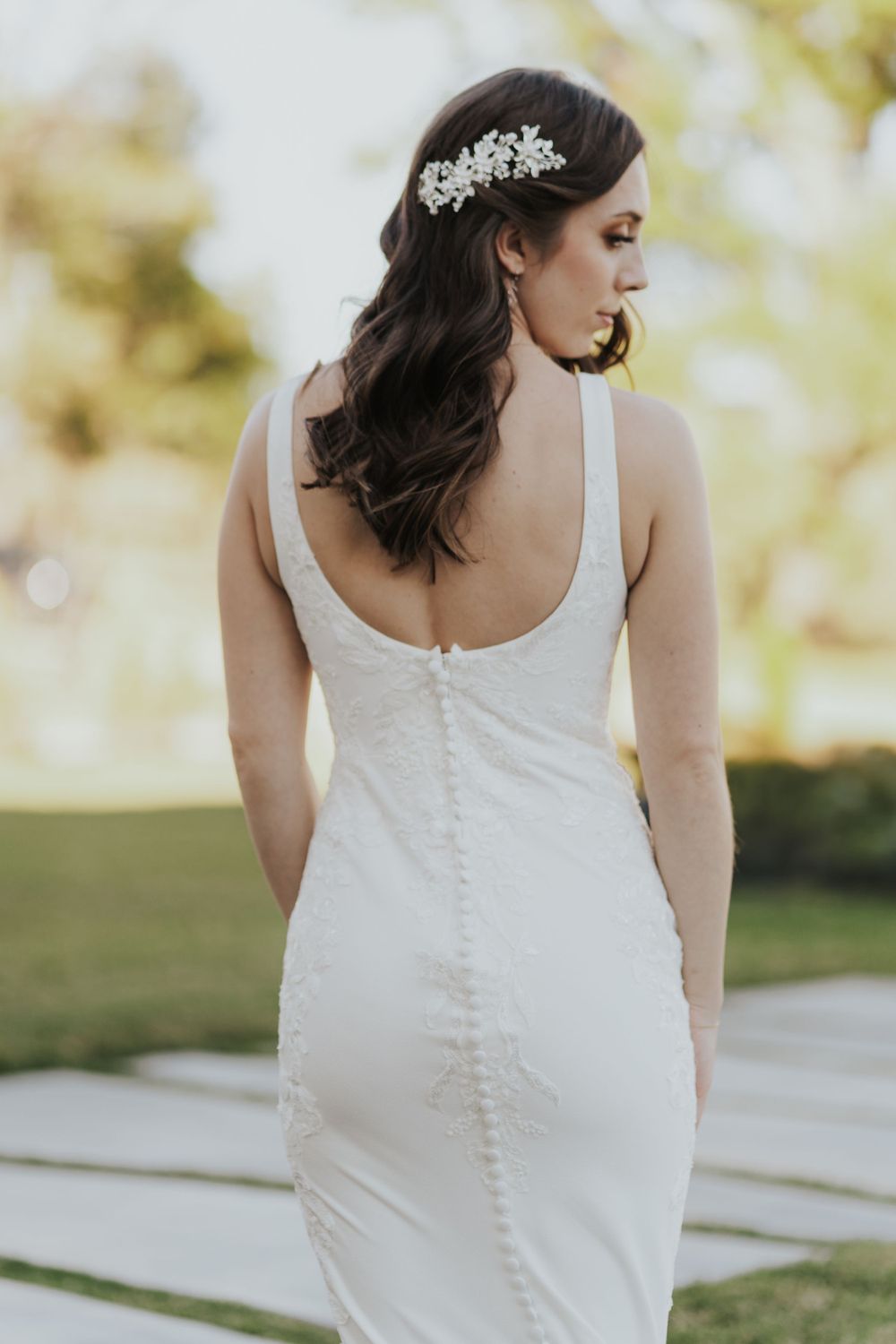 Back view of wedding dress showing elegant button details and fitted silhouette.