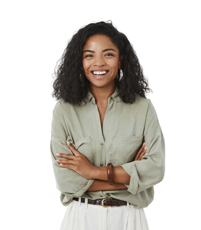 Professional studio portrait of someone in a light olive button-down shirt and white pants with arms crossed and a bright smile.