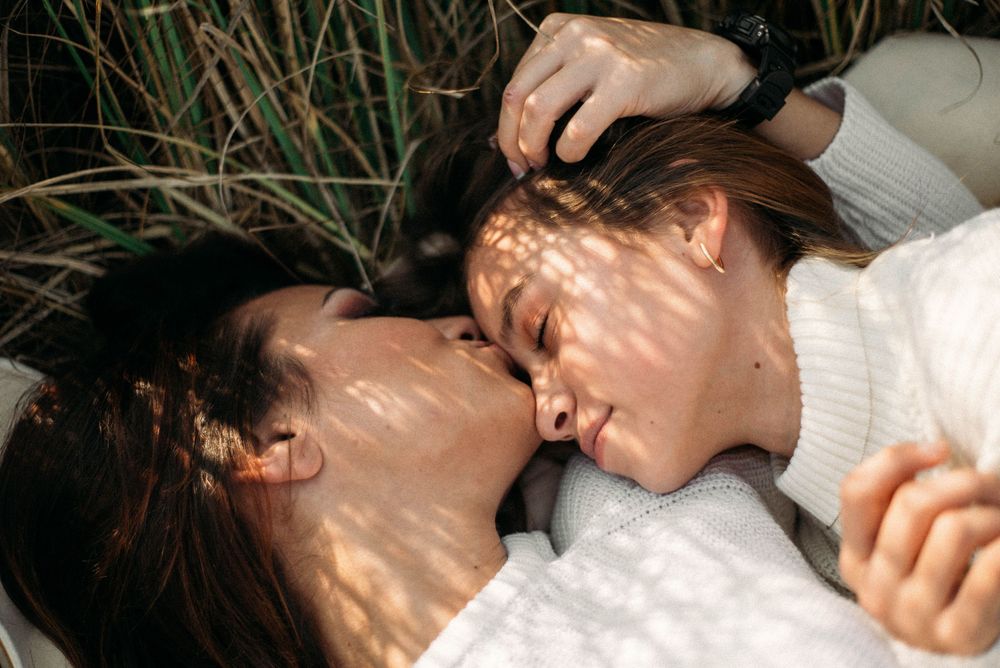 Romantic sequence with dappled sunlight creating patterns through leaves.