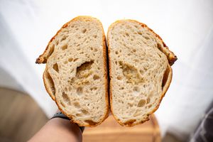 Close-up view of a sliced sourdough bread showing its airy crumb structure and texture.