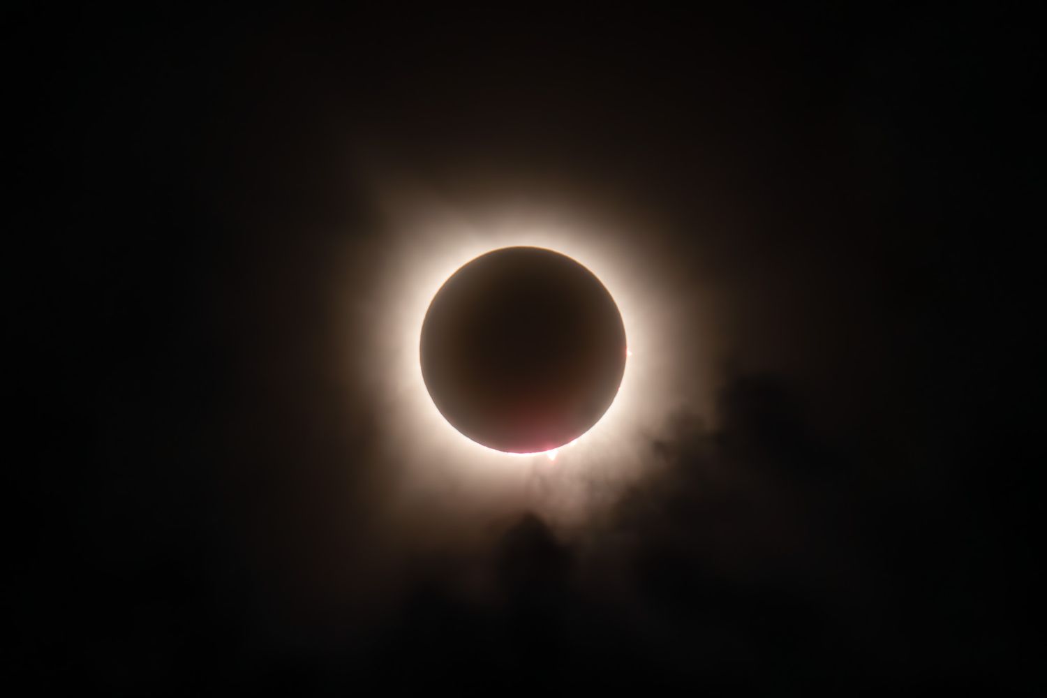 A stunning solar eclipse creating a perfect ring of light in the dark sky.
