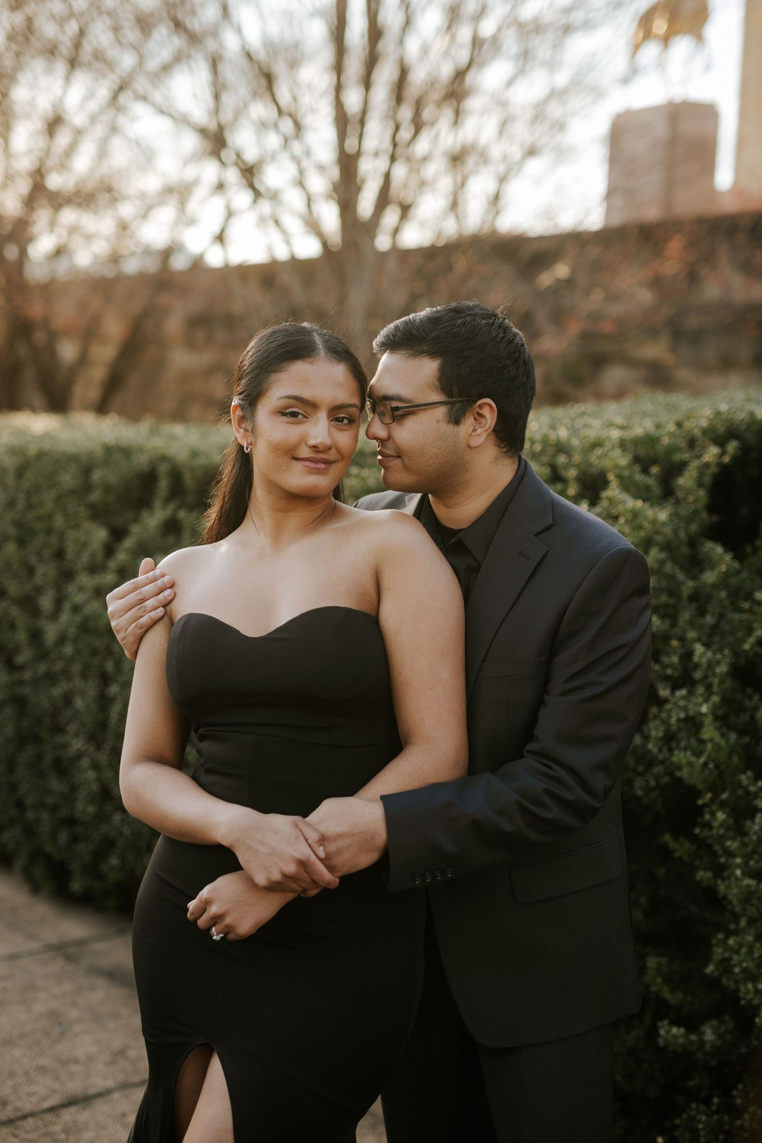 A joyful couple in traditional attire strolls through lush greens at The Drexelbrook Catering & Event Center—timeless elegance in Philly.