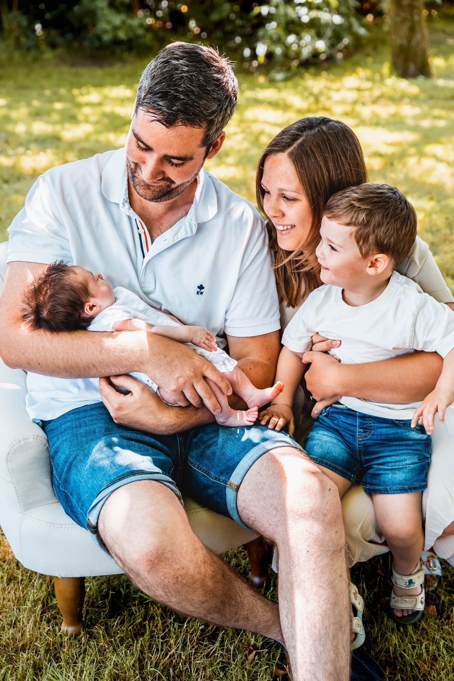 Family enjoying quality time together while seated in a modern white chair outdoors.
