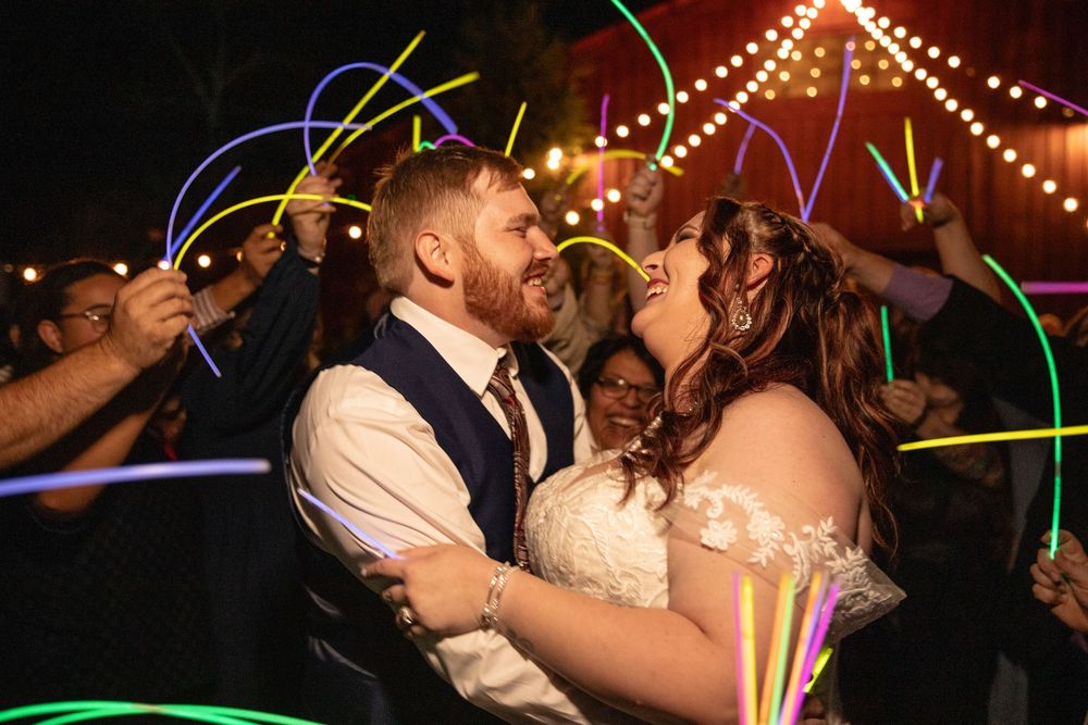 Fun wedding exit idea of glow stick with the bride and groom