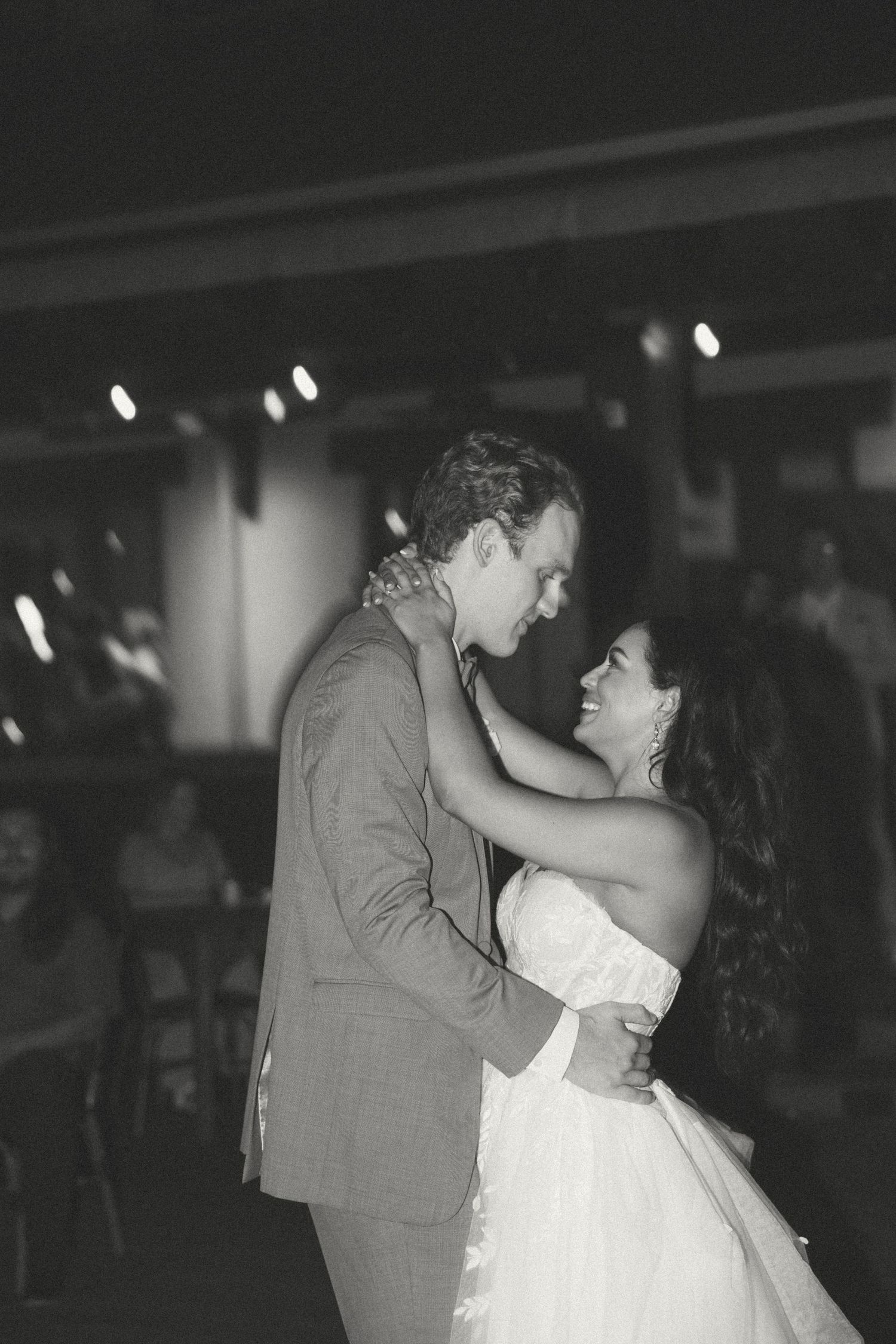 Intimate dance moment captured in black and white during wedding reception.