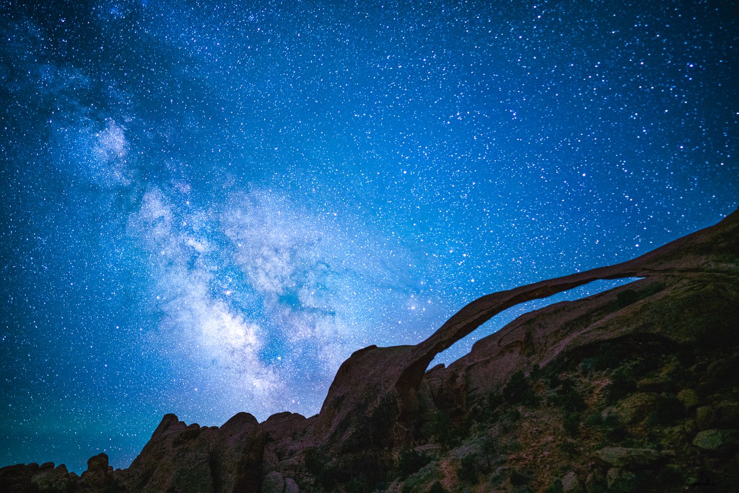 Milky way over landscape arch red rocks in Utah