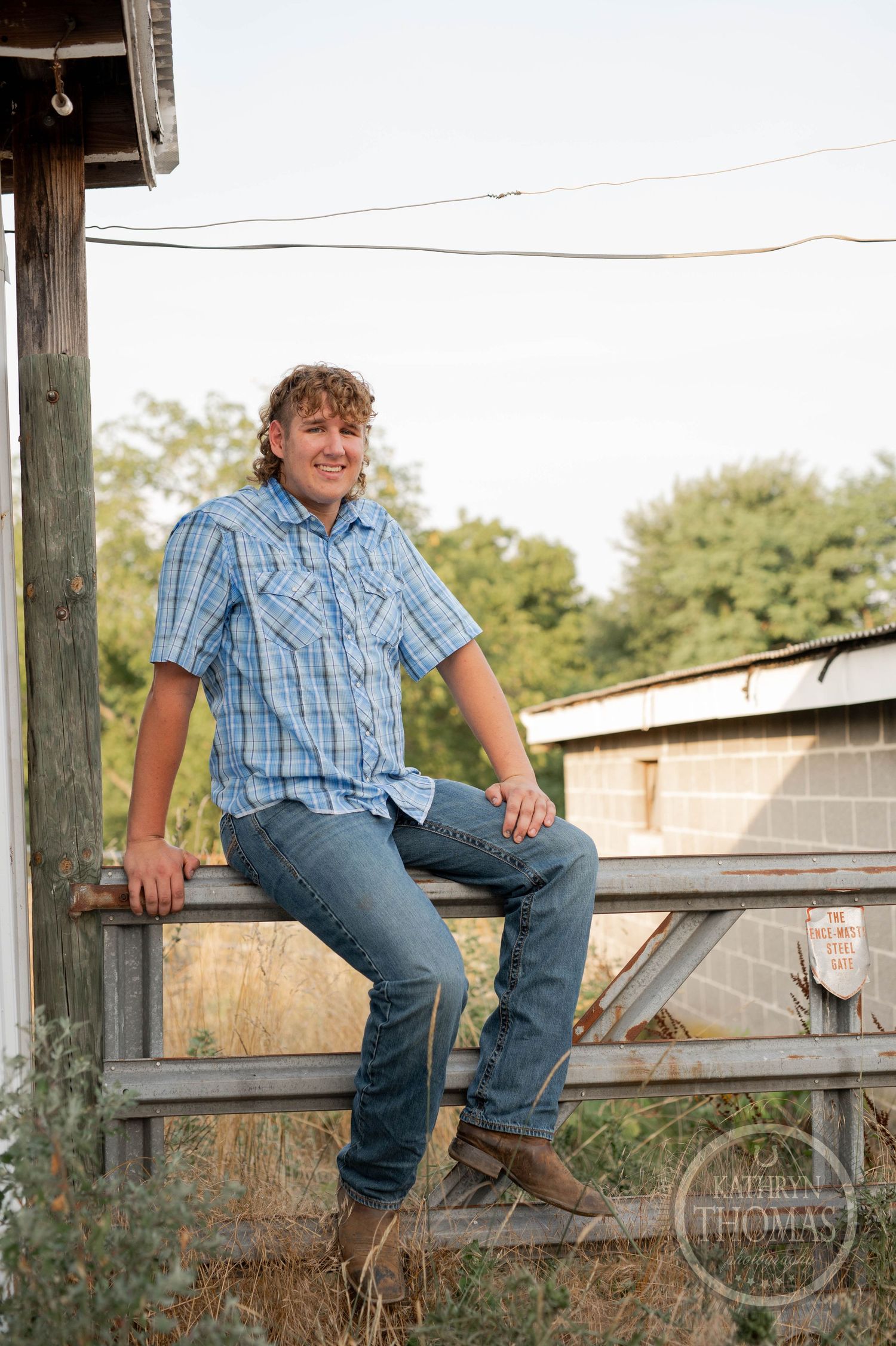 A casual outdoor photo on a wooden deck wearing western-style clothing.
