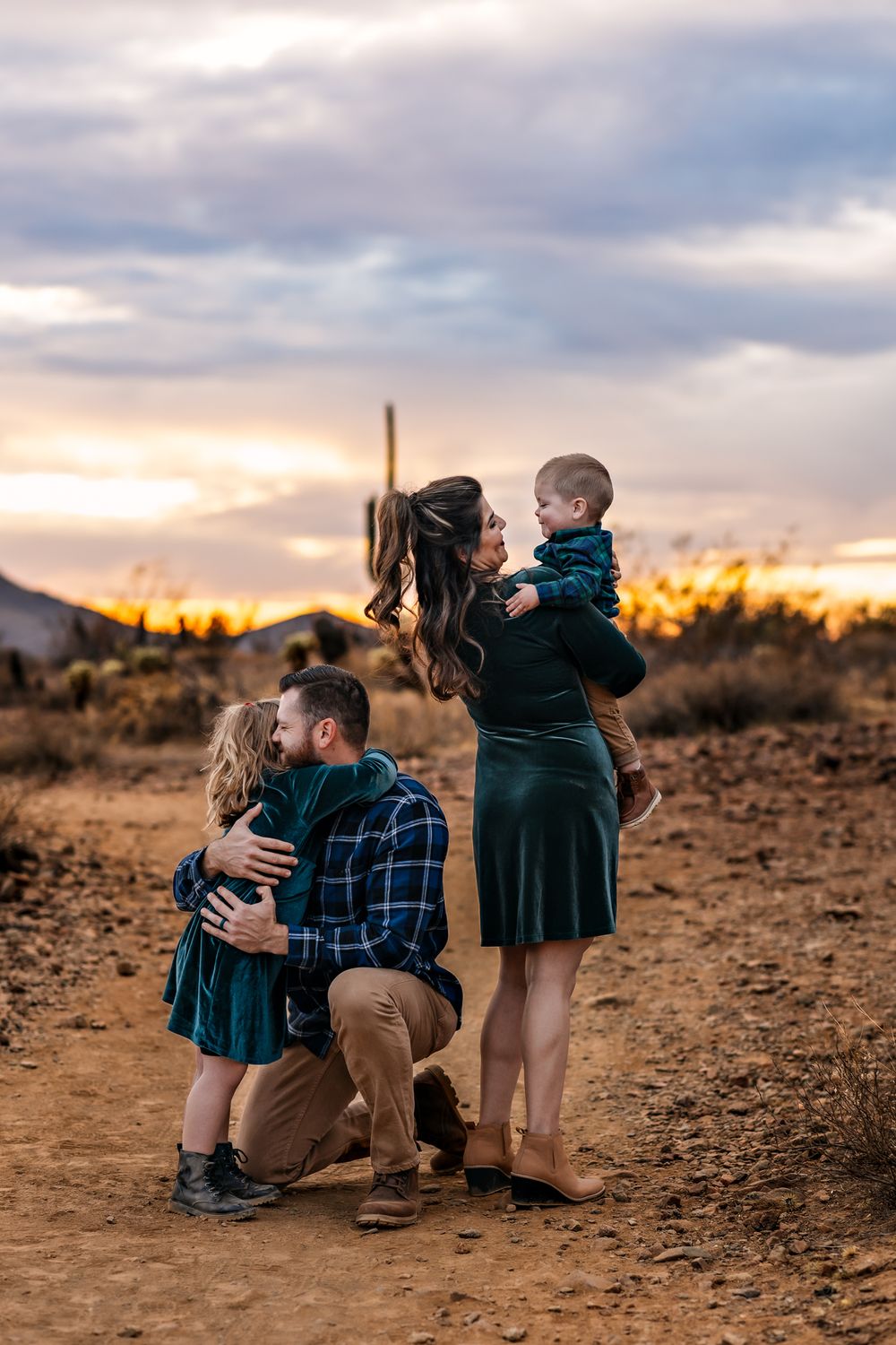 Family portrait at sunset in desert landscape with mountains in background in Phoenix Arizona