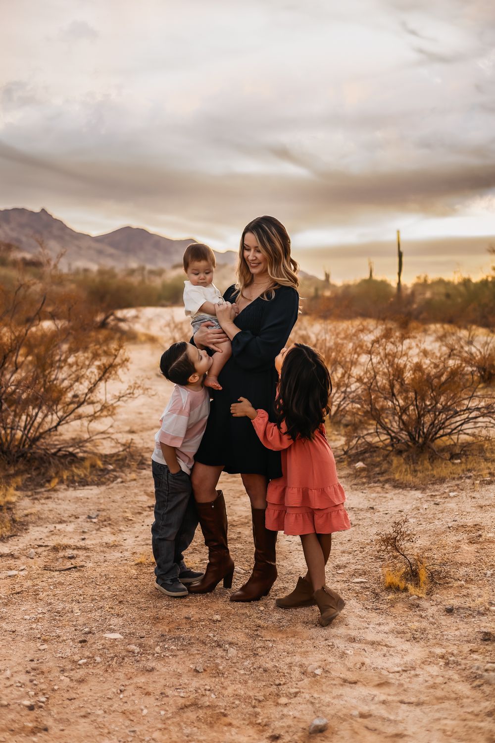 Mother in blue dress with children in desert setting during golden hour at South Mountain in Phoenix, Arizona