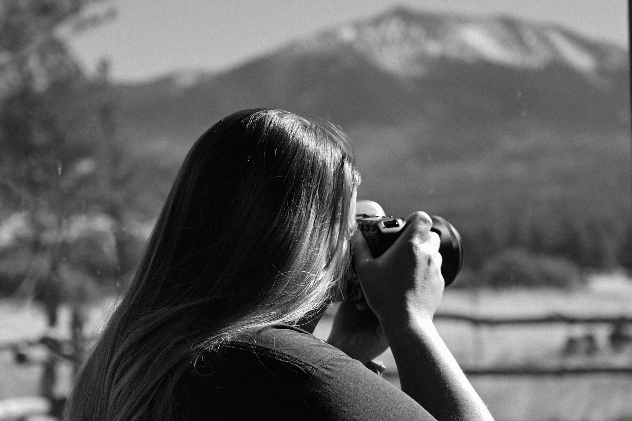 Black and white Moody image of girl with camera branding photo shoot