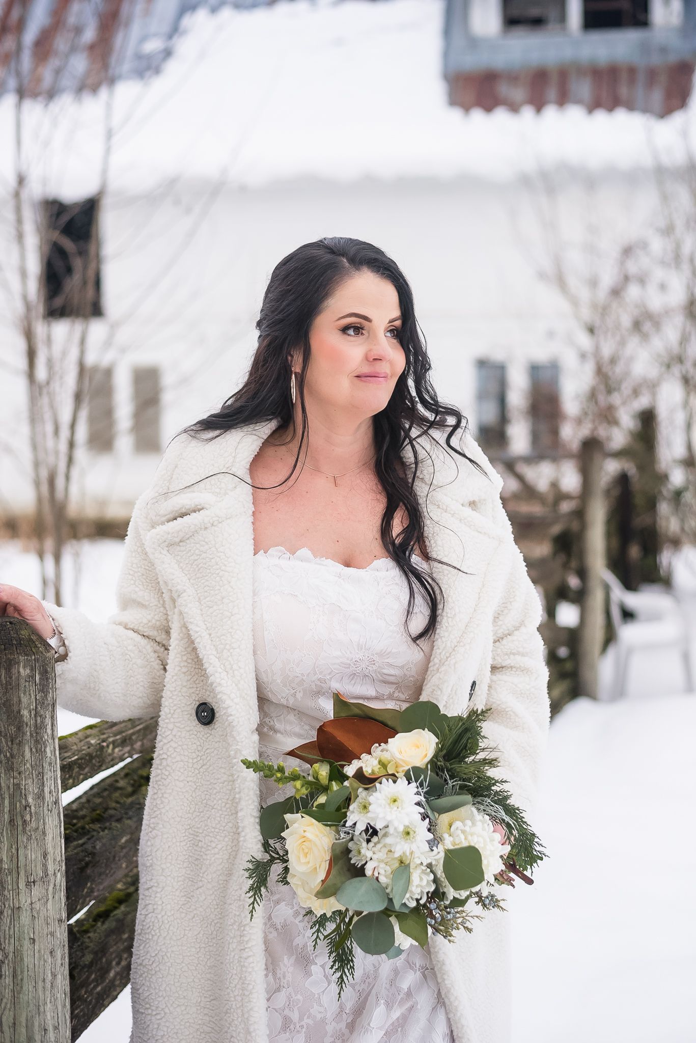 A bride gently smiles as she looks over to her groom on her winter wedding day. Photo taken at Estate 248 by Kari Mills Photography.