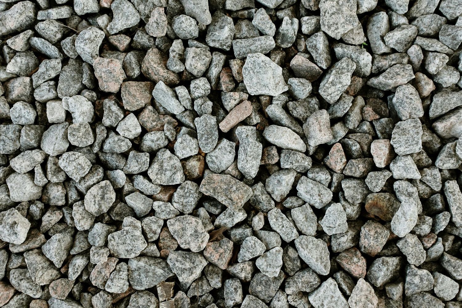 Close-up texture of crushed gray gravel stones.