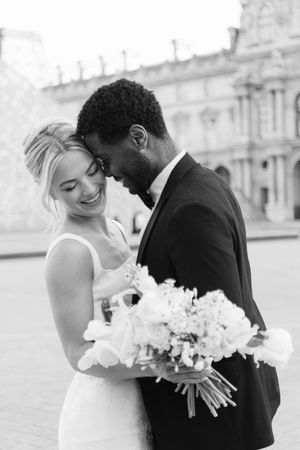 A romantic black and white wedding photo sequence showing a couple embracing while holding a white floral bouquet.