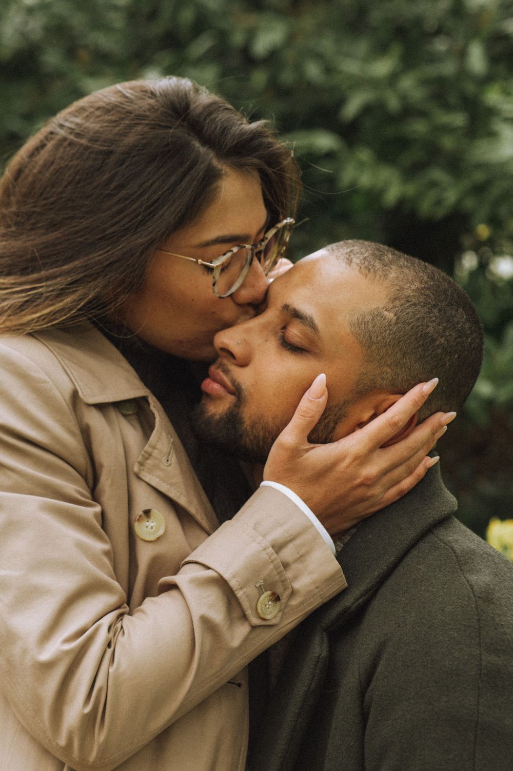 An intimate moment shared between a couple in autumn coats.