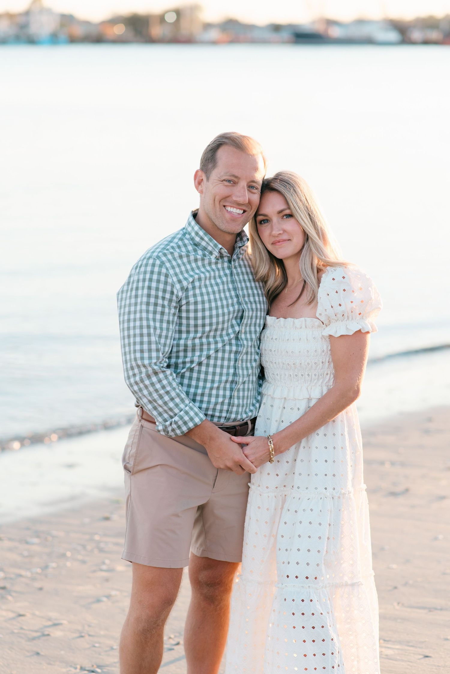 A Manasquan beach photo session of a couple with a white dress at Fisherman's Cove by Lauren Marie Photography.