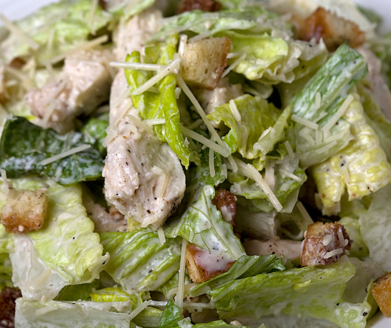 Fresh Caesar salad with grilled chicken, crispy croutons, romaine lettuce, and shaved Parmesan cheese.