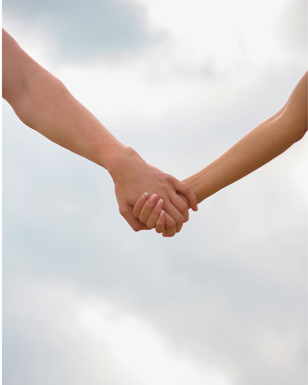 A poignant moment of holding hands during a legacy photography session, symbolising love, connection, and the passing of time