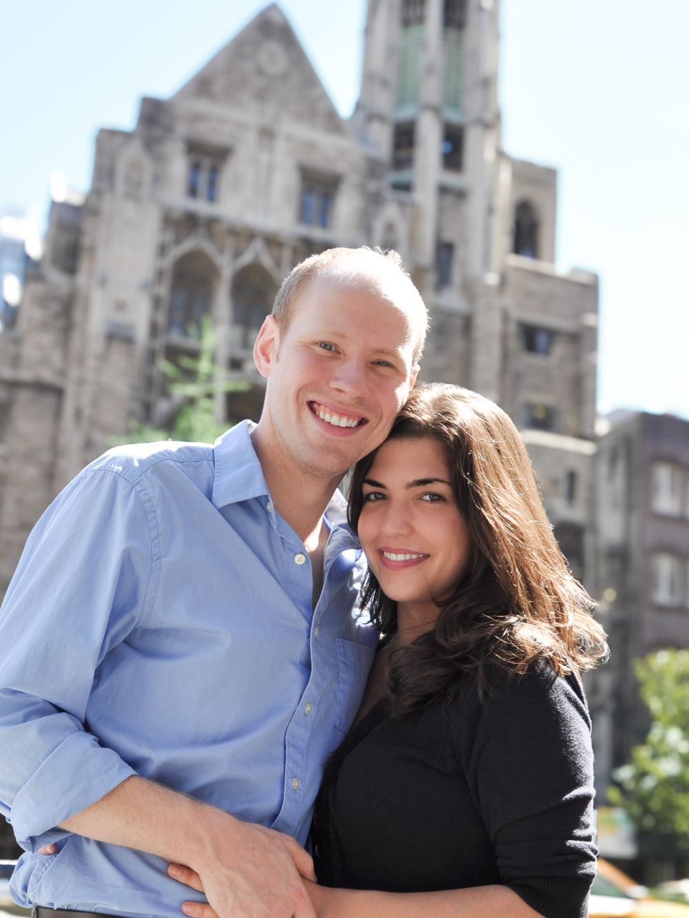 Engaged couple embracing outside Central Presbyterian Church in NYC, celebrating the place where their love story started.