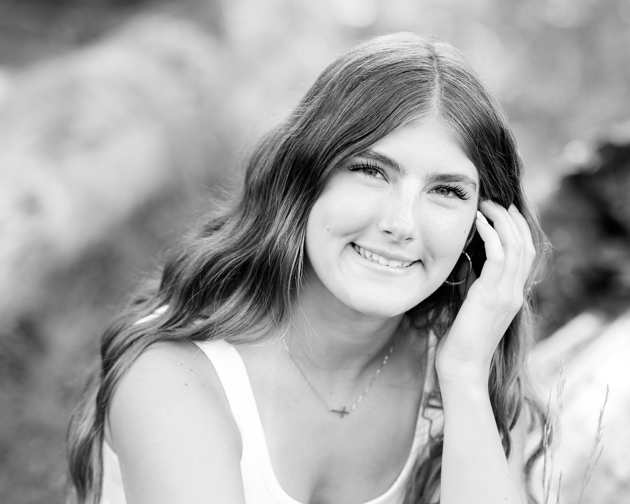 Black and white portrait with gentle smile against soft bokeh background. Wallowa Lake, Joseph, Oregon