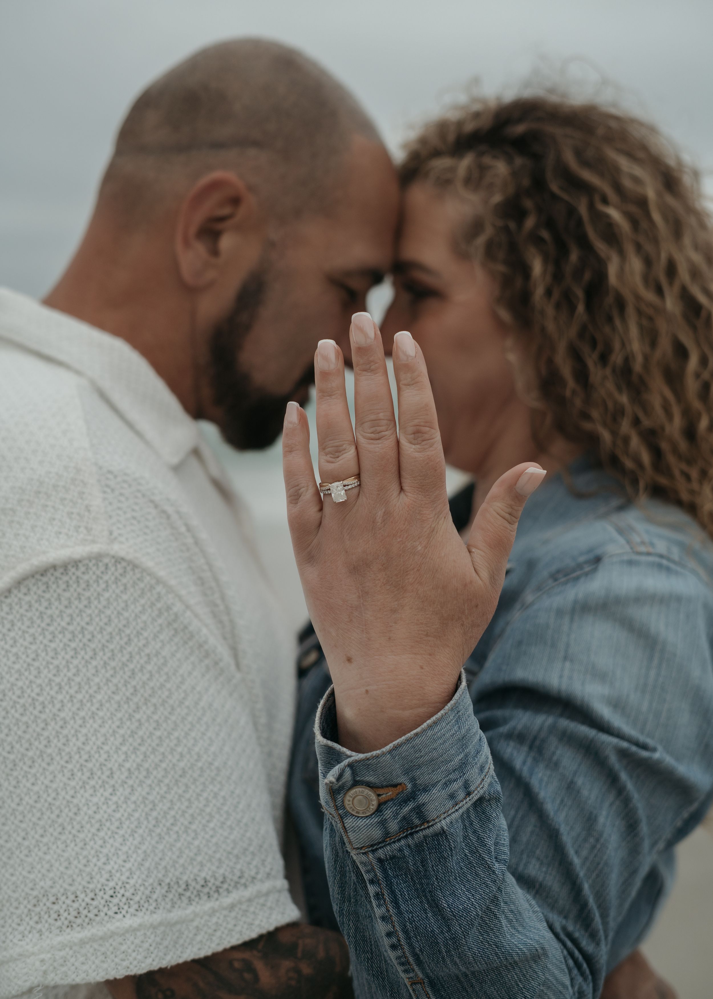 Romantic couple celebrating an engagement show off their wedding ring in a series of intimate close-up shots.