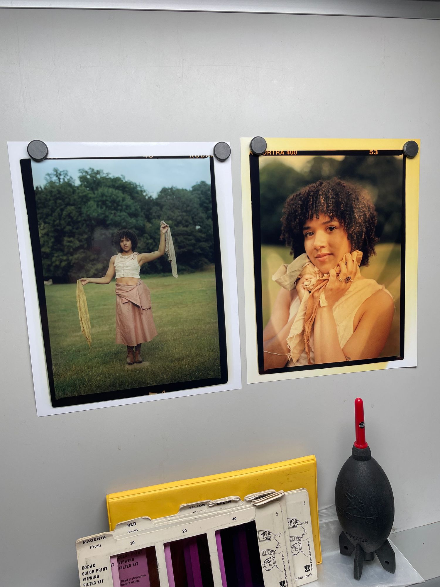 Contact sheet of vintage photographs displayed on a gray surface with yellow accents.