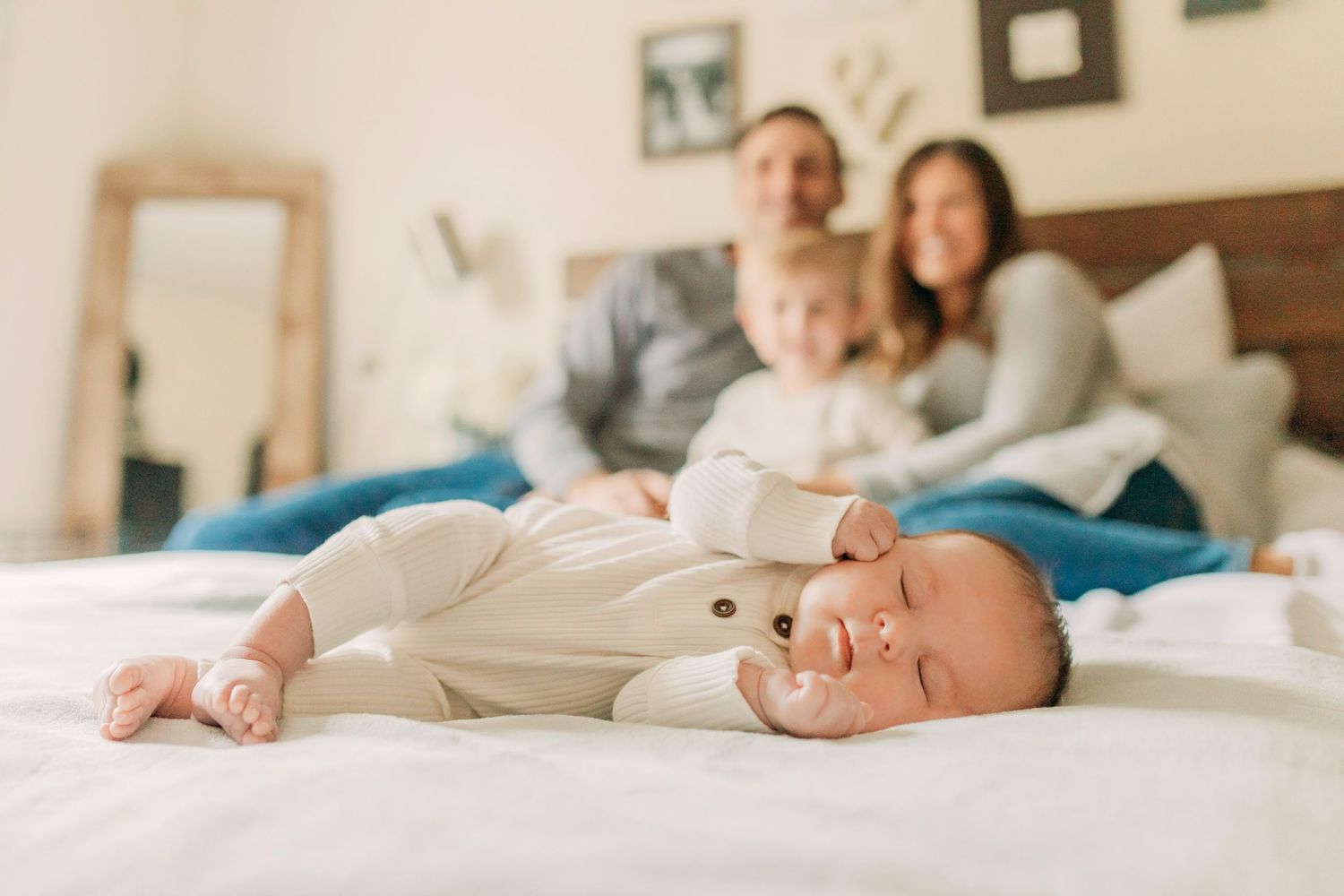 A peaceful family moment in bed with baby and golden retriever.