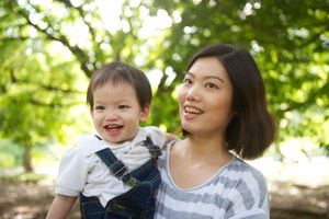 Smiling mother and toddler son enjoying a sunny day in a Toronto park, taken by Phoebe Lee Photo