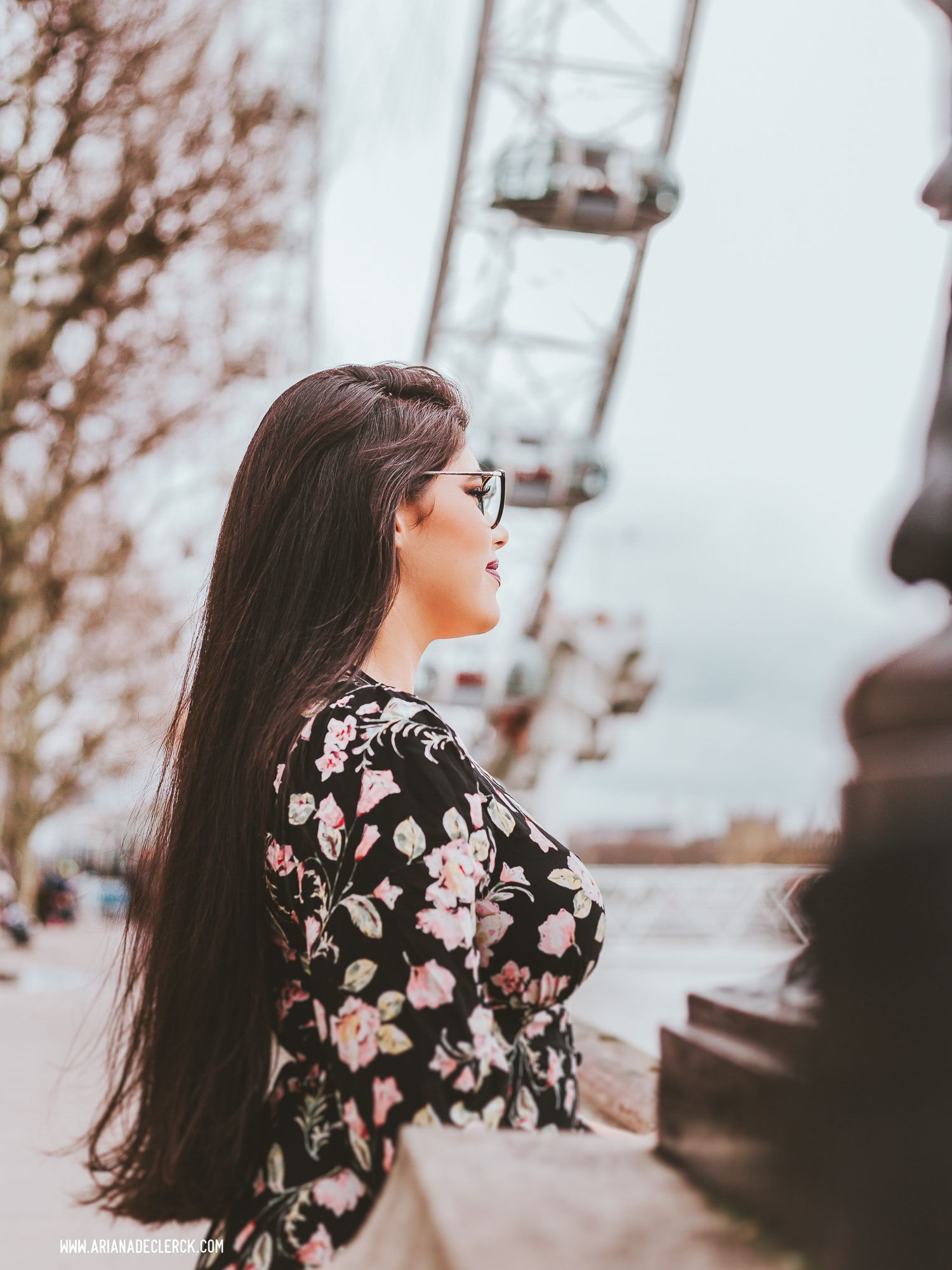 Floral dress fashion photo with London Eye in soft focus background.