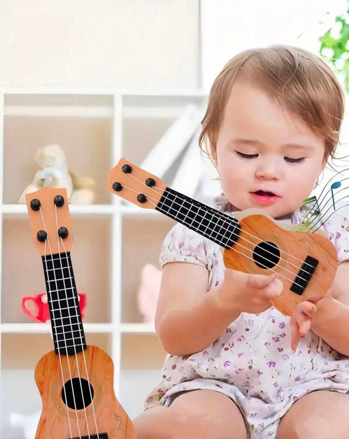Small child playing with a wooden ukulele while sitting on a white chair.