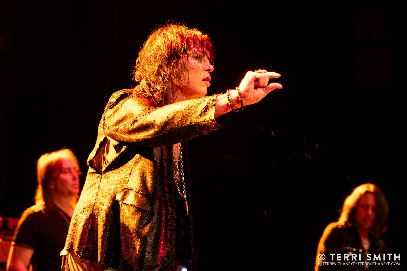 Tom Keifer and #keiferband performing live at the Sherman Theater in PA. Tom is aglow in yellow light and gesturing a "tiny bit".