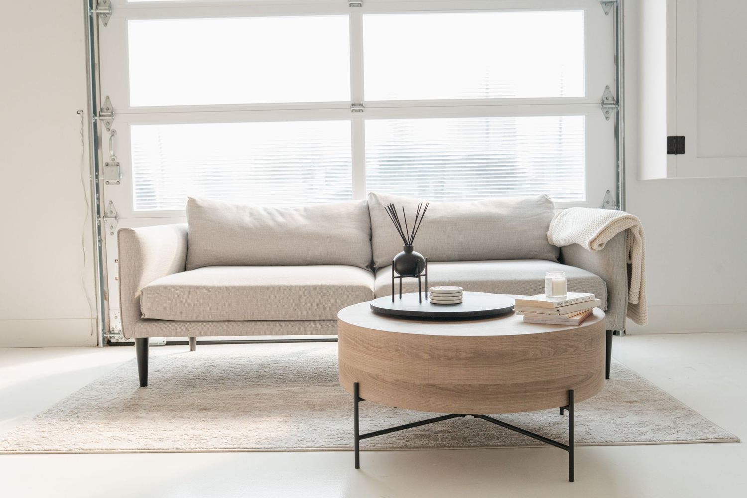 Elegant Scandinavian living room interior with modern minimalist furniture, white decor, and natural lighting.