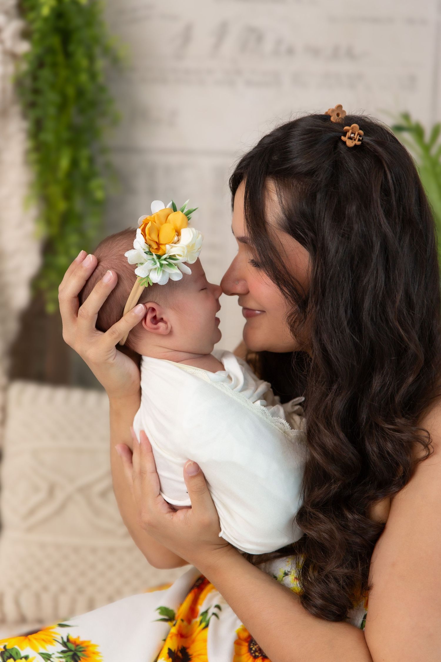 Tender maternal moment with yellow flower crown and sunflower theme.