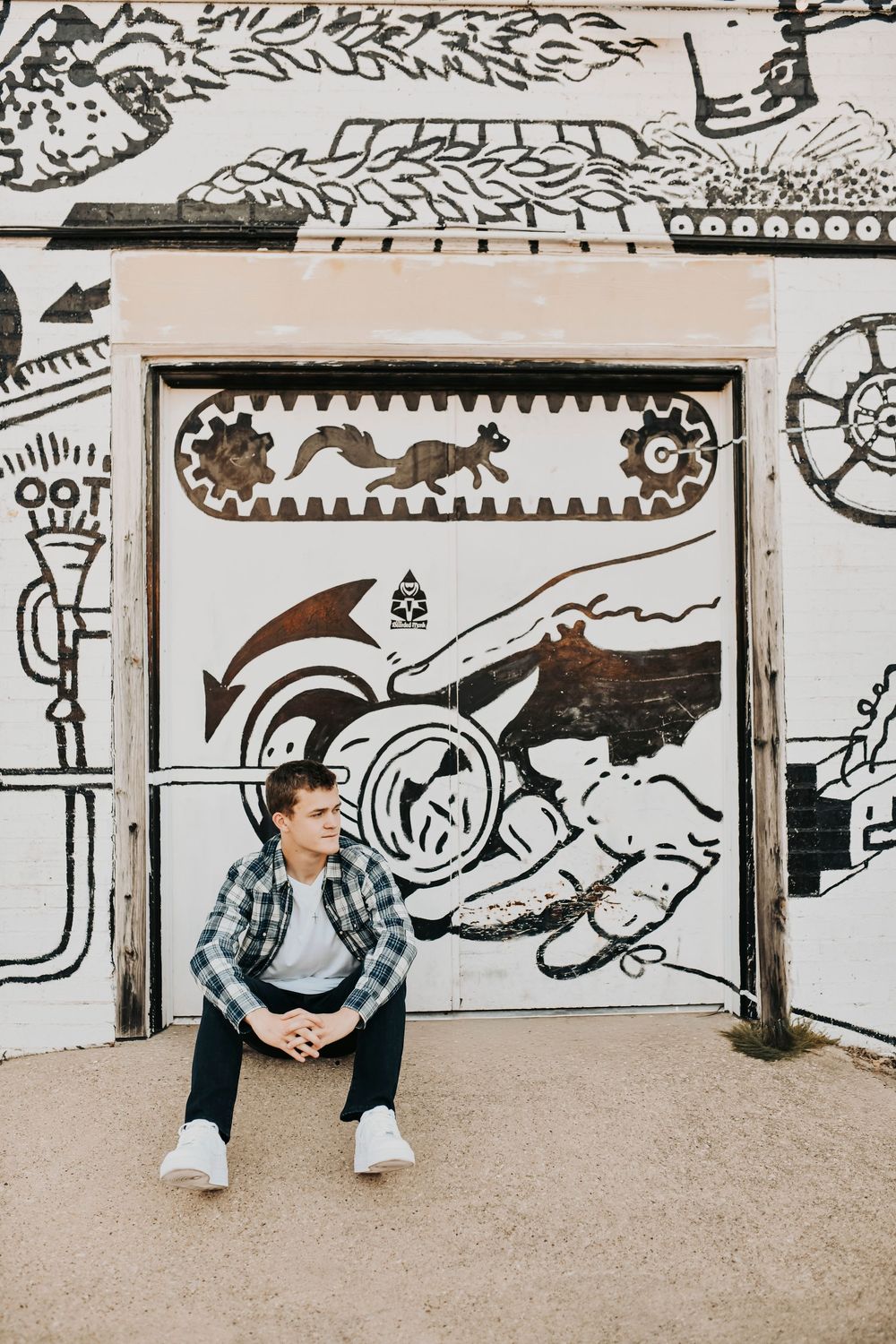 2026 graduate poses in denton graffiti wall senior photo
