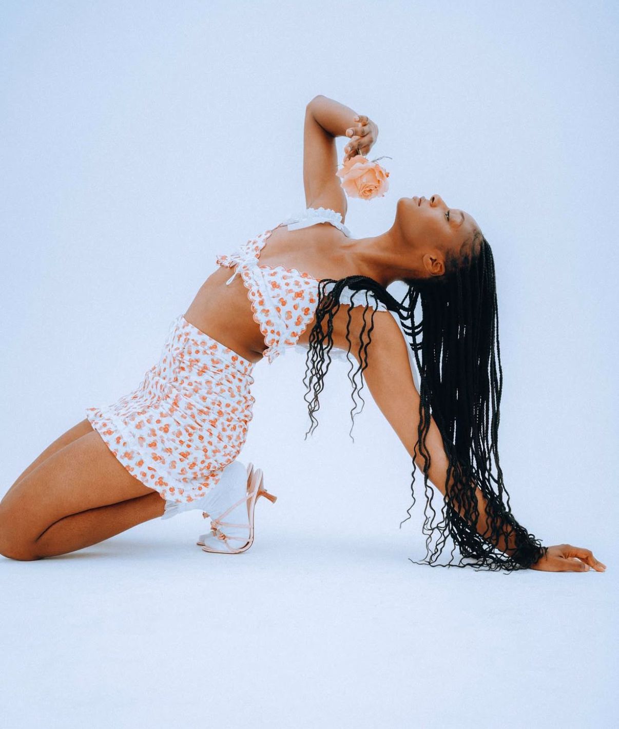 Expressive dance movements captured in white lace outfit against minimal studio setting.